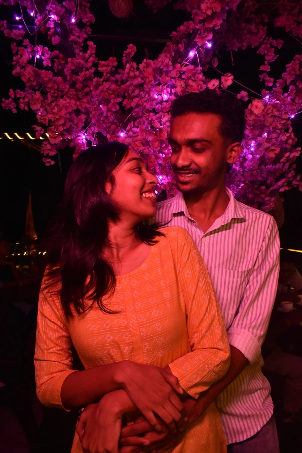 Couple portrait under pink lights